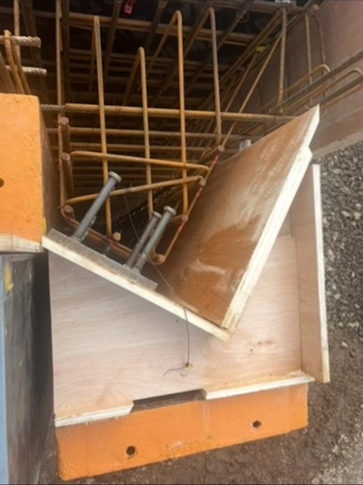 Cast-in steel plate fixed within the reinforcement