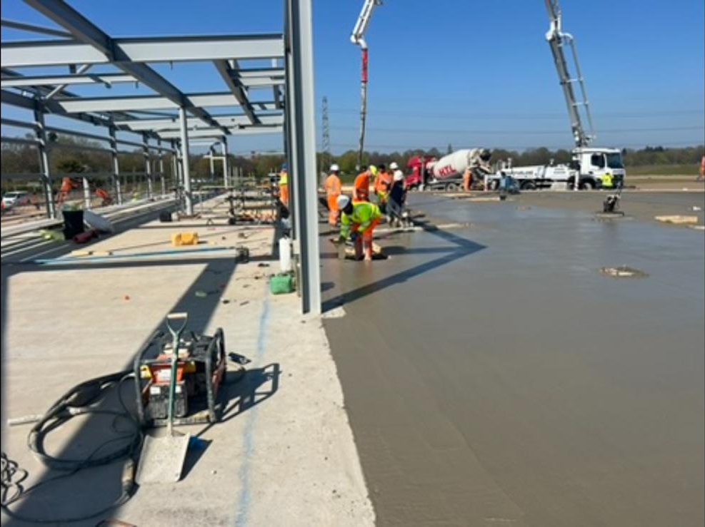 Concrete placed and levelled inside a new steel frame