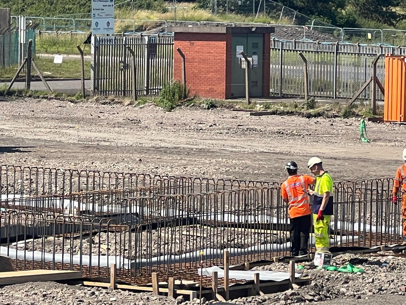 Operatives beside ground beam reinforcement