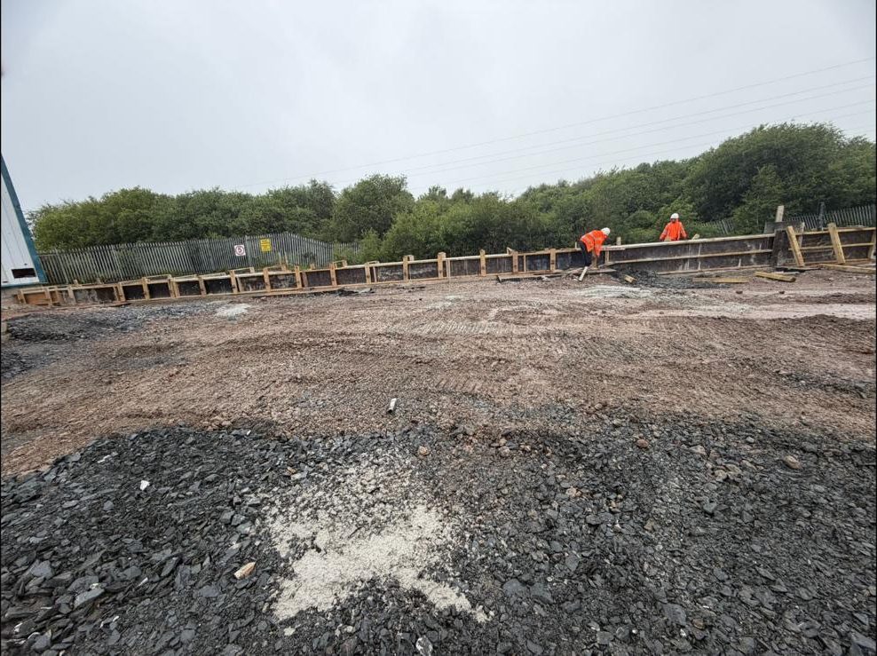 Stone formation prepared ahead of the slab, with edge forms along the fence line
