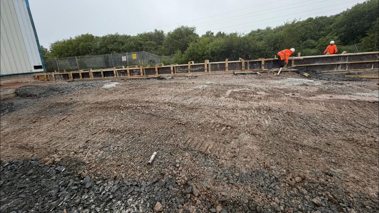 Edge formwork set along the slab beside the building