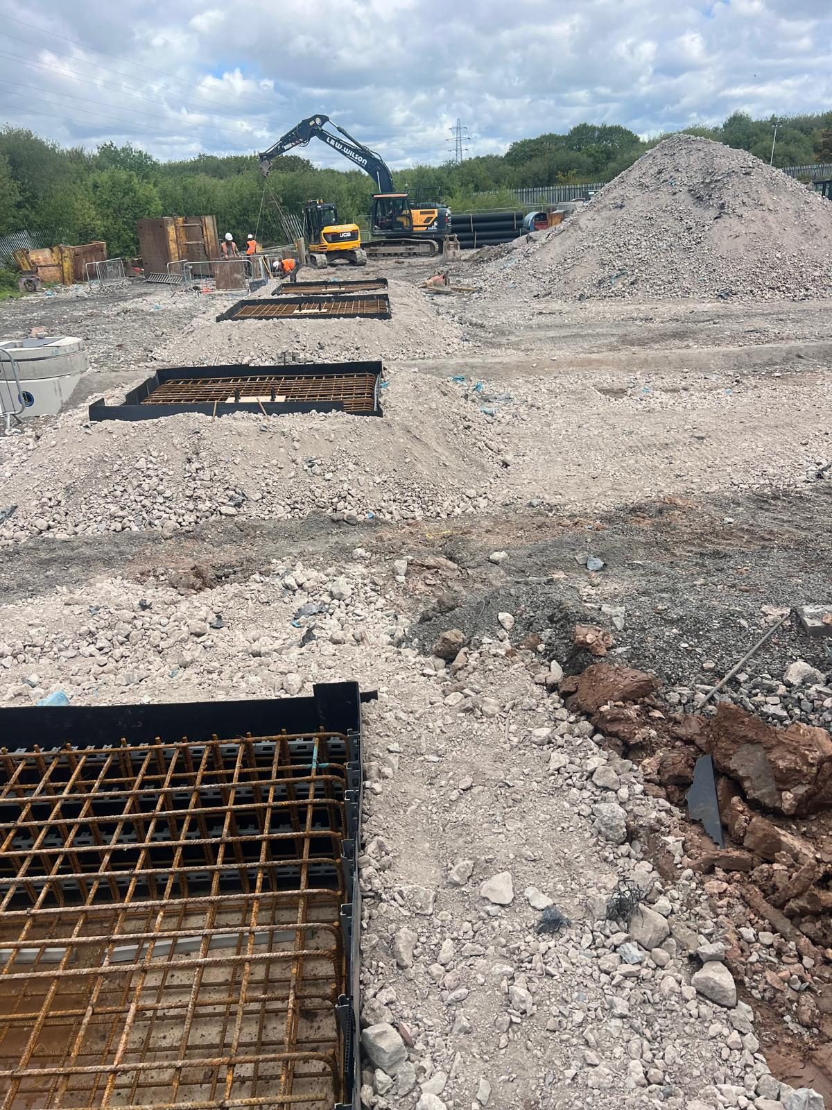 Row of pad foundation excavations with reinforcement
