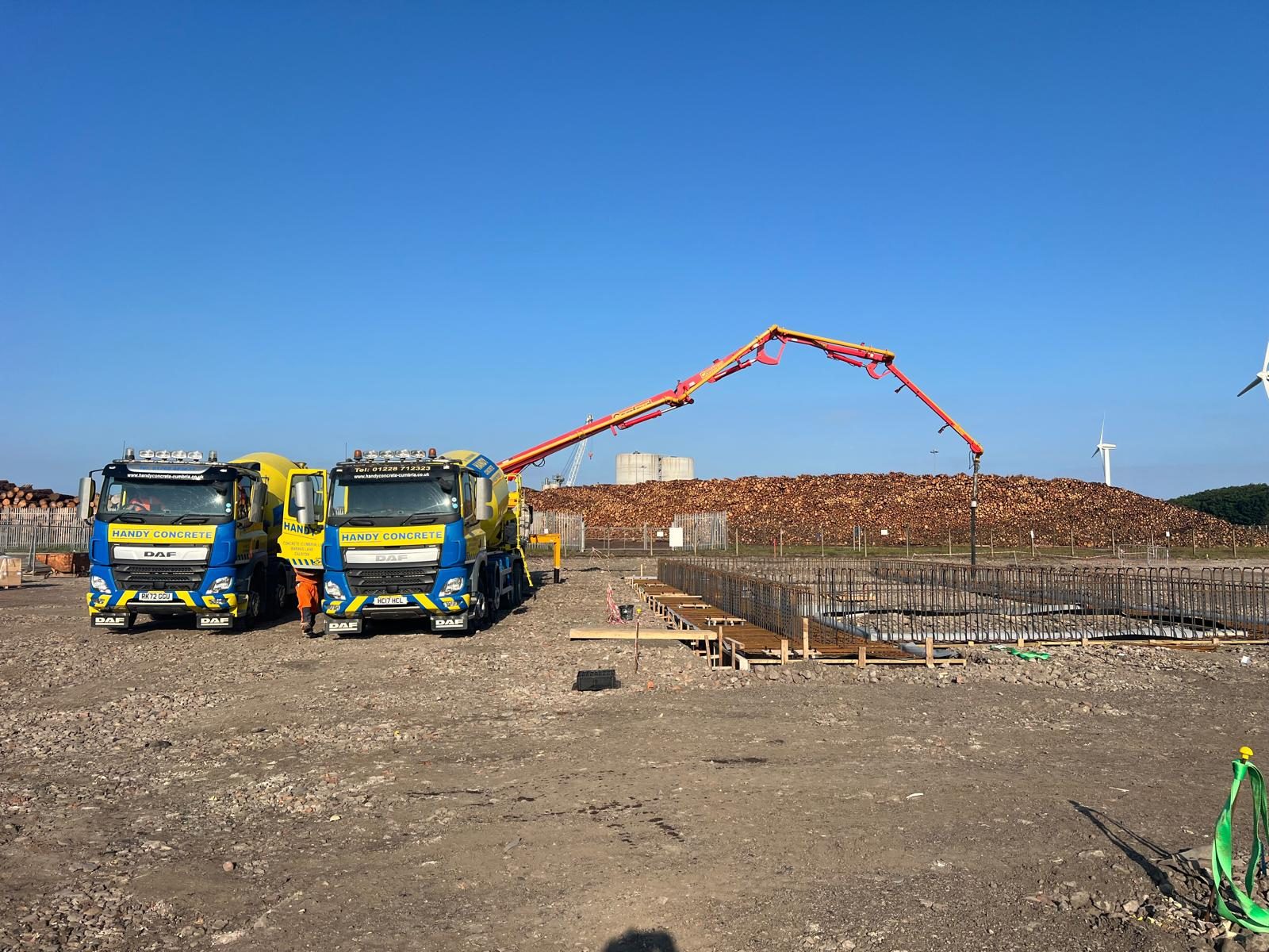 Mixer trucks and boom pump at a foundation pour