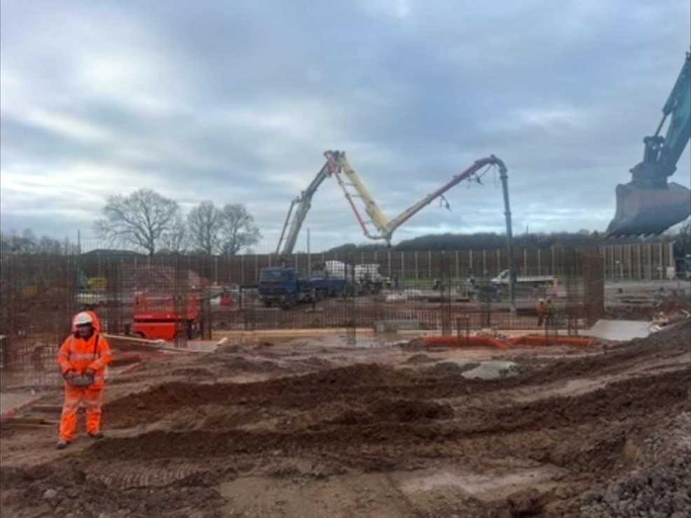 Two boom pumps working on a foundation pour