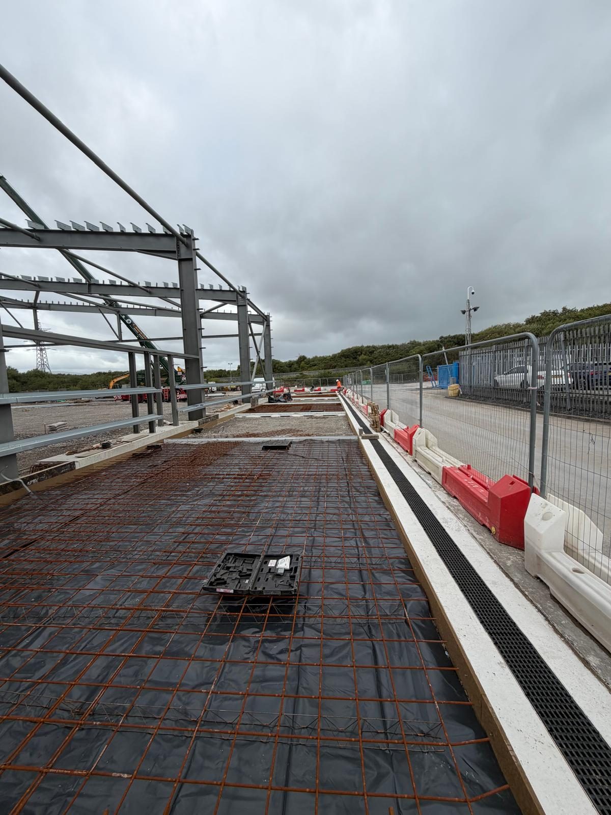 Mesh reinforcement laid beside a drainage channel and a new steel frame