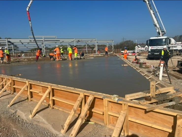 Slab pour placed by boom pump inside timber edge forms