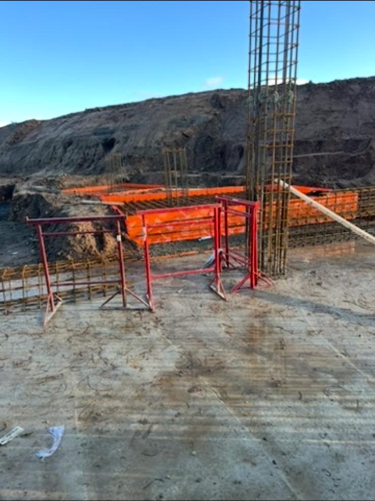 Starter bars rising from a new slab with edge protection