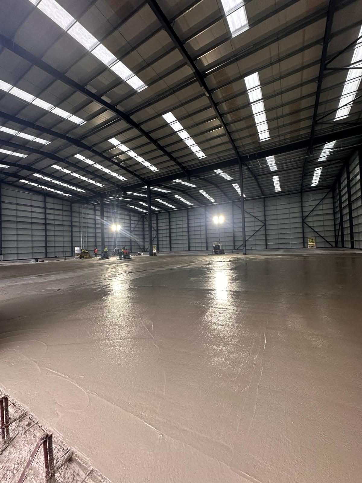 Newly finished floor inside a lit warehouse