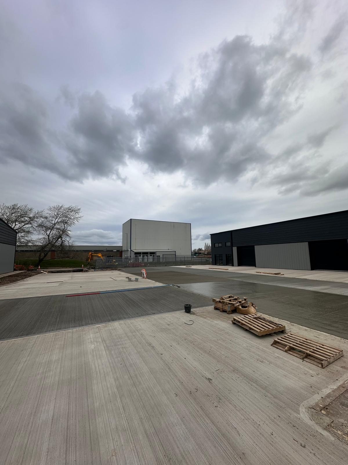 External concrete yard with materials on pallets