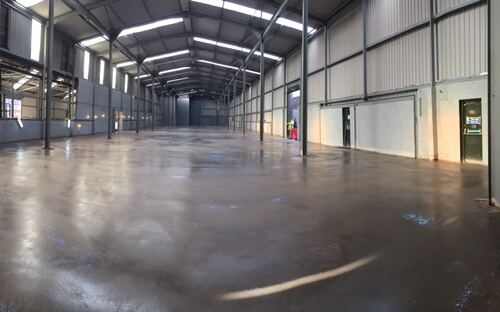 Smooth sheen-finished internal concrete floor in a long warehouse